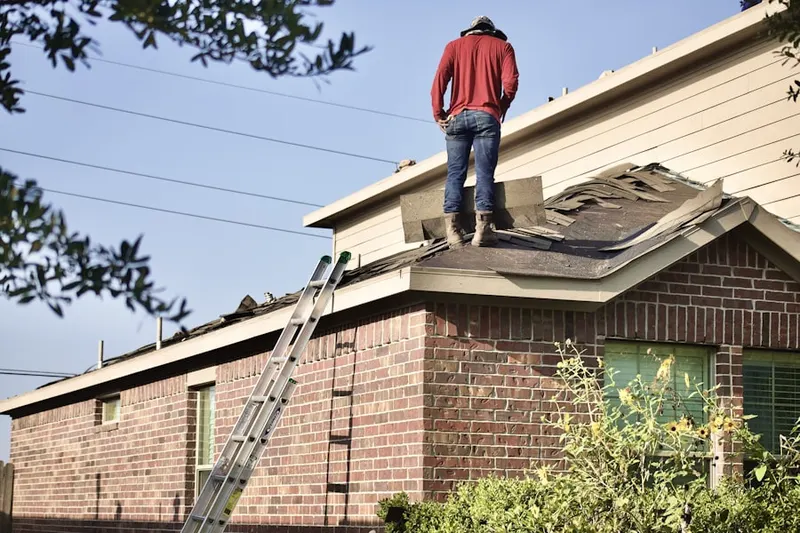 Professional roofer working on a residential roof in Lakeland Village
